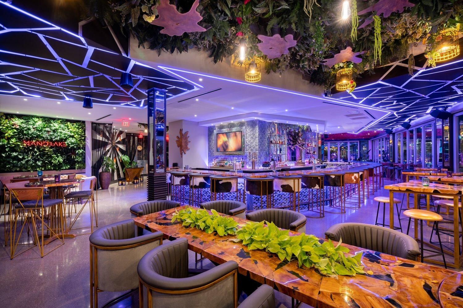 Lounge with violet lighting and a living plant wall